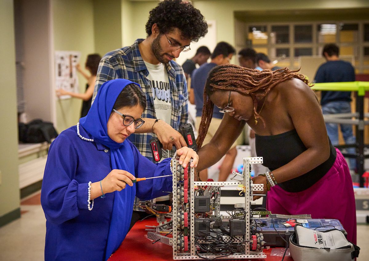Diverse UWC-USA Students collaborate on a robotics project in their physics classroom.