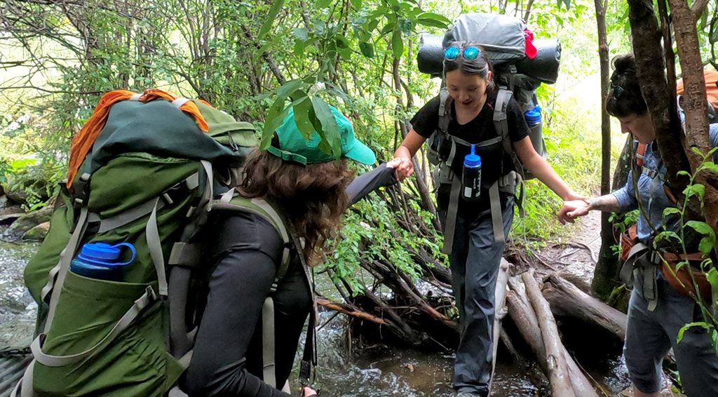 UWC-USA students help each other through the Pecos wilderness as part of the wilderness program.