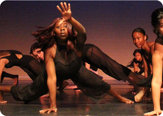 Diverse students on stage for a dance performance.