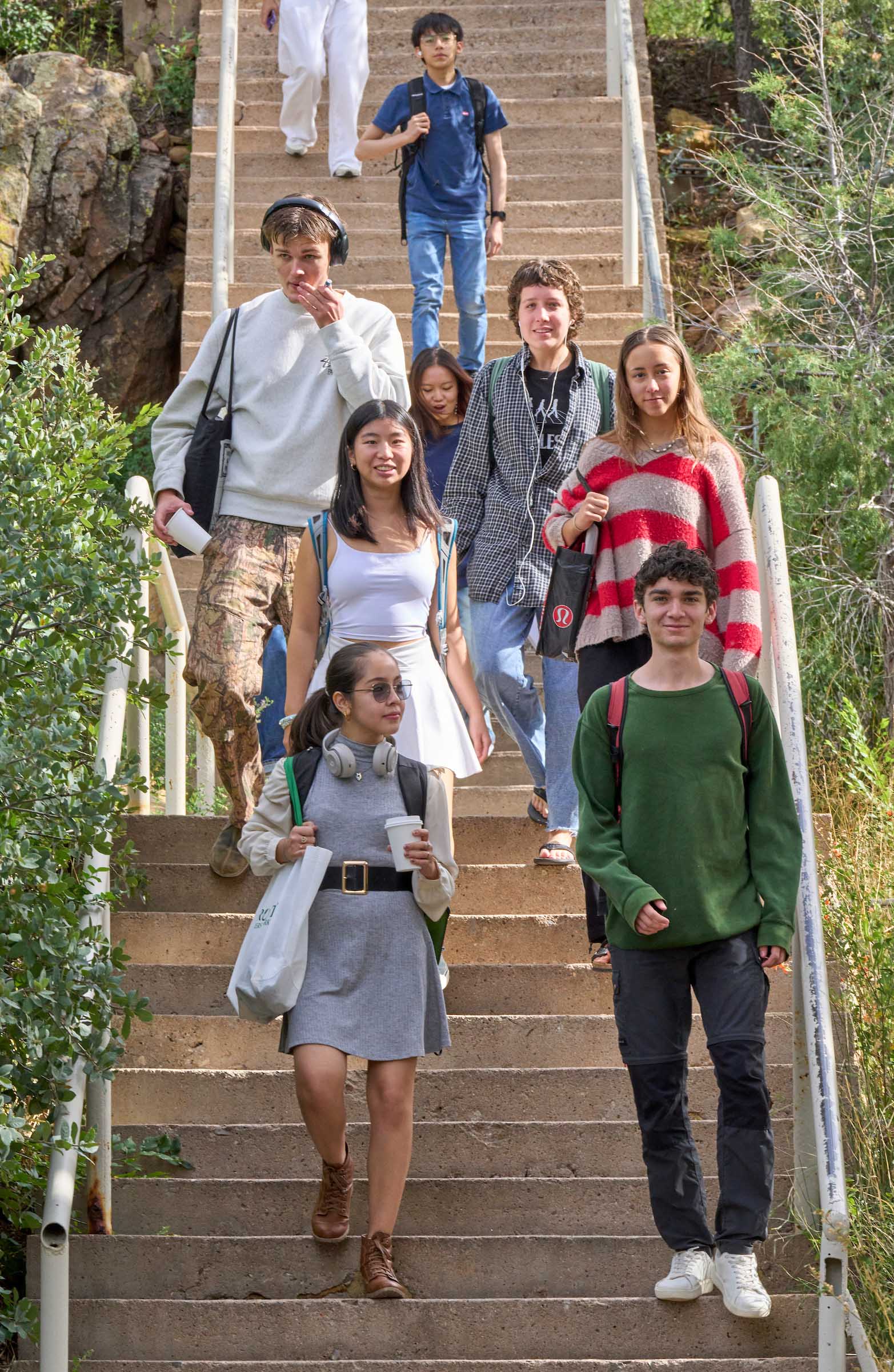 Diverse students walk down the stairs to class at UWC-USA.
