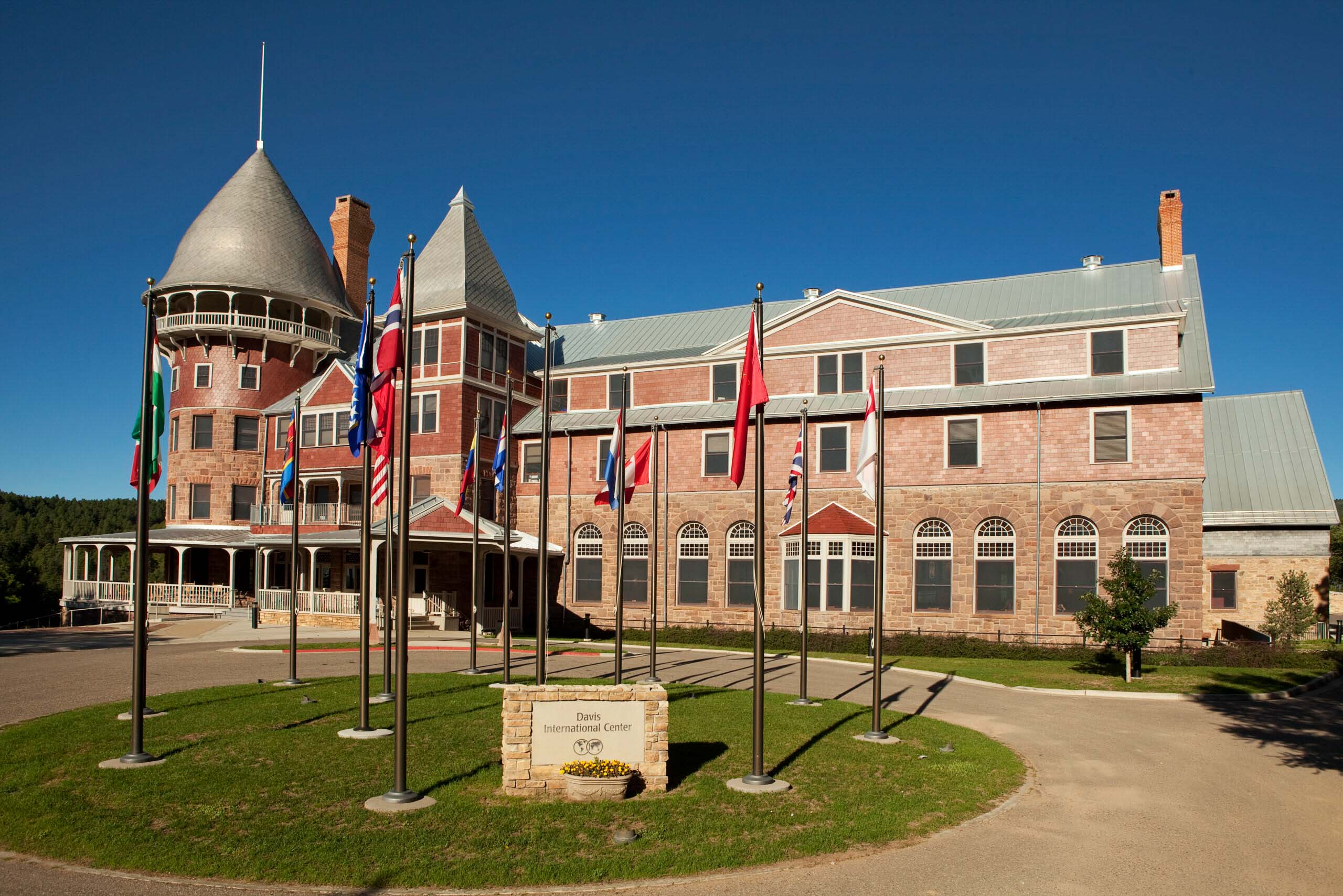 The Montezuma Castle with international flags, reflecting UWC-USA’s diverse, global community and IB academic spirit.