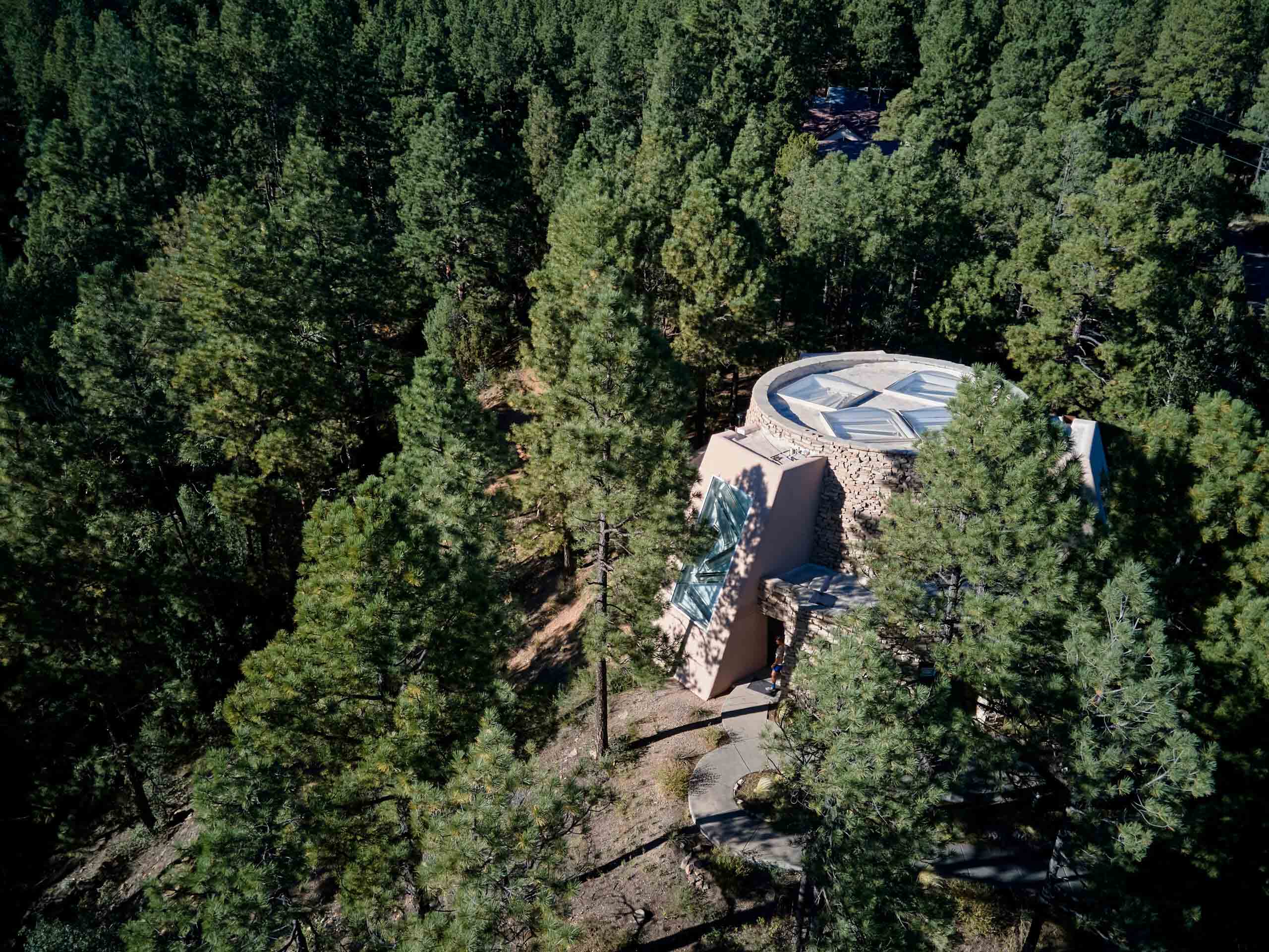 The Dwan Light Sanctuary with geometric roof set in pine forest, reflecting UWC-USA’s focus on sustainability and community.