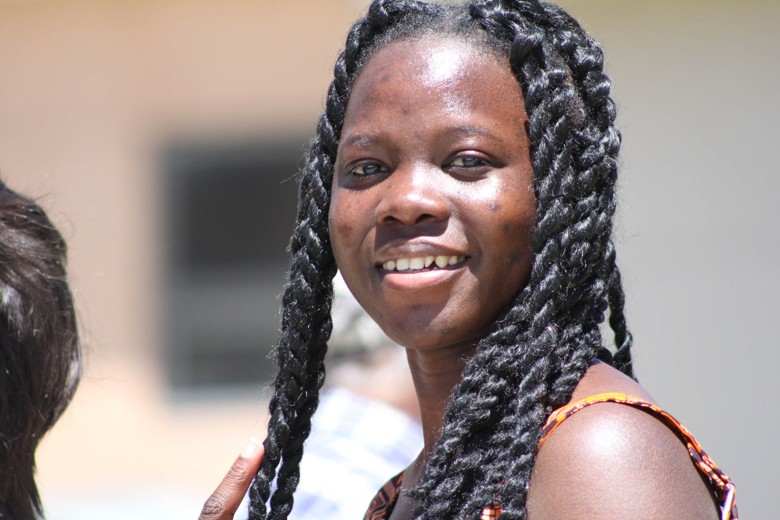 A student smiles on campus, reflecting UWC-USA’s global community and welcoming academic environment.