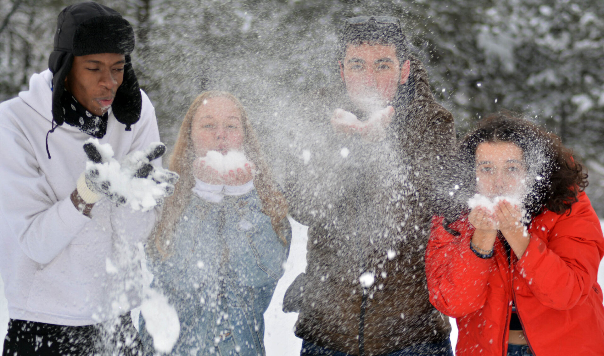 Diverse group of students enjoy playing in the snow on the UWC-USA campus during winter.