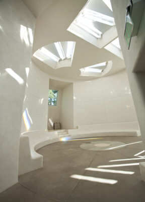 Sunlit circular room in the Dwan Light Sanctuary with skylights and curved seating, fostering community, reflection, and global connection at UWC-USA.