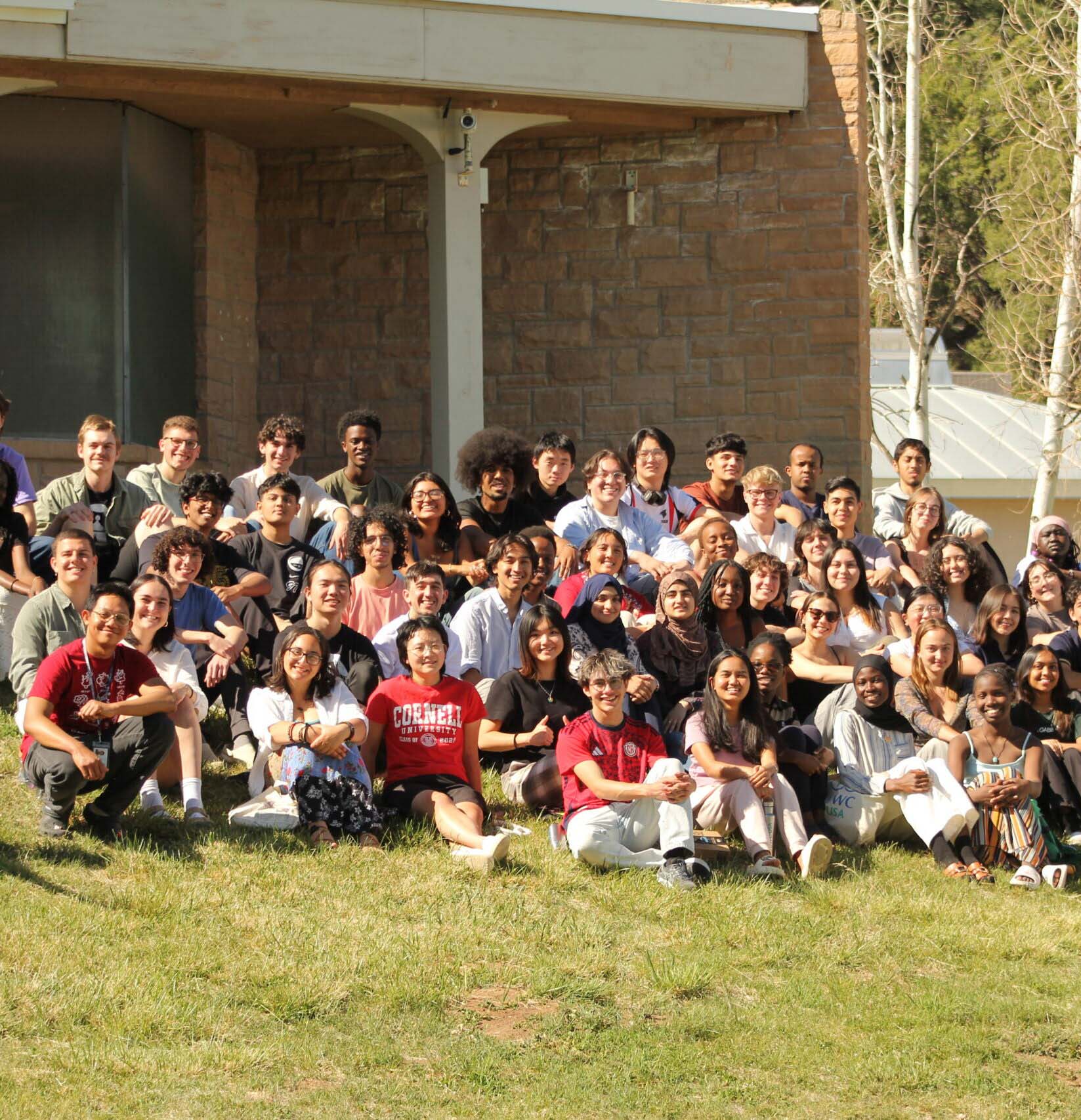 Diverse Davis Scholar students gather on campus lawn, reflecting UWC-USA’s global IB community, commitment to service, and shared purpose.