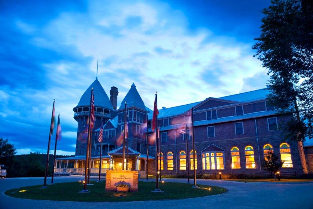 United World College USA’s historic Montezuma Castle at dusk, international flags celebrating global community and diversity.