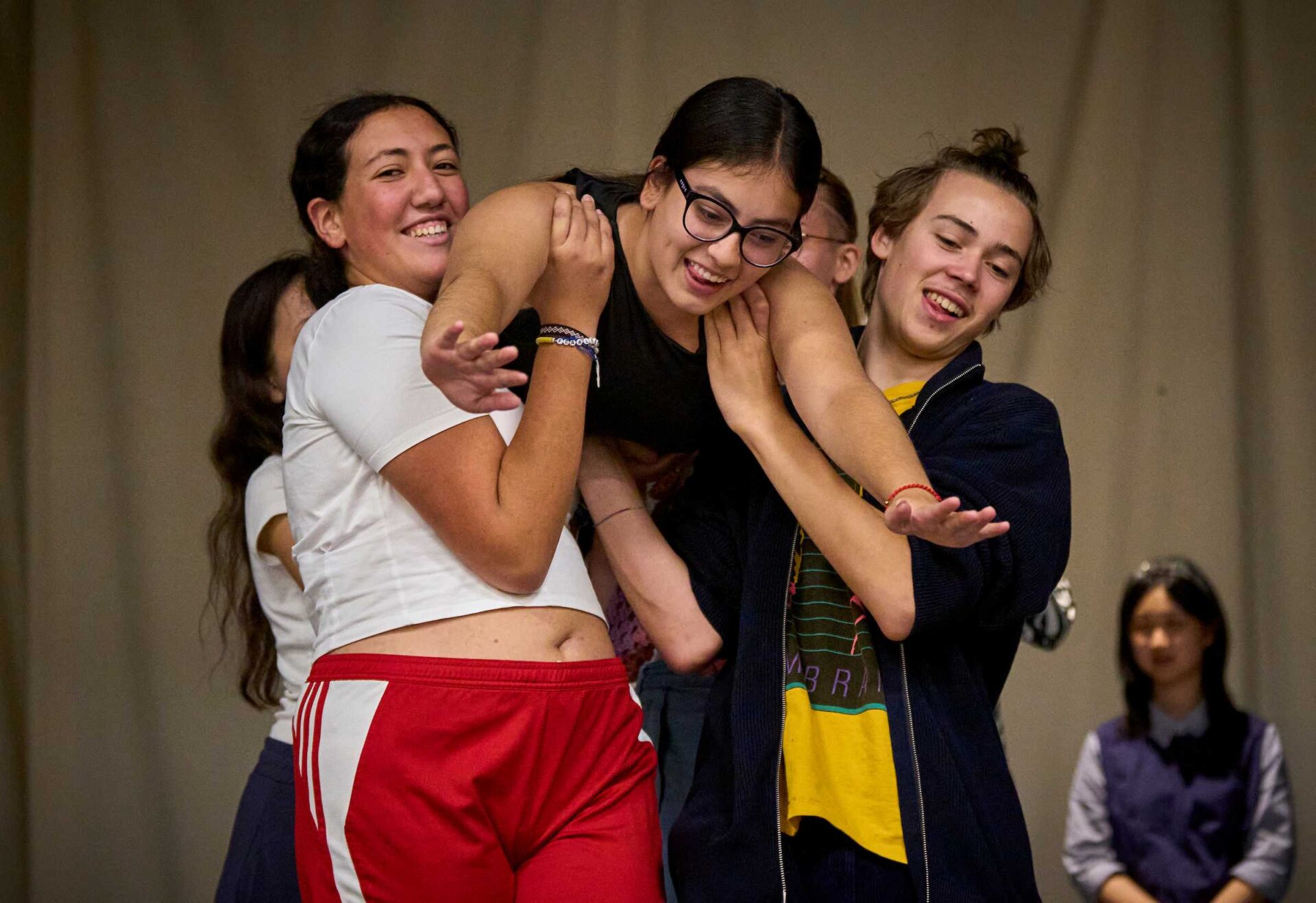UWC-USA Students lifting fellow student up in the air as part of a theatre activity in the arts & culture department.