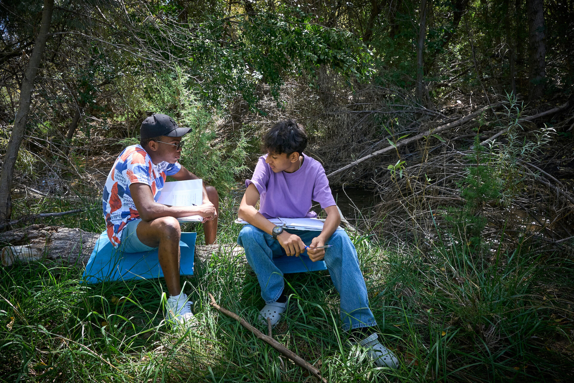 Students from diverse backgrounds engage in academic discussion outdoors, embodying UWC-USA’s commitment to global learning.