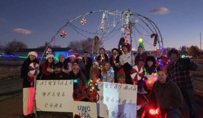 Students from diverse backgrounds celebrate together on a festive float, reflecting UWC-USA’s global community and spirit.