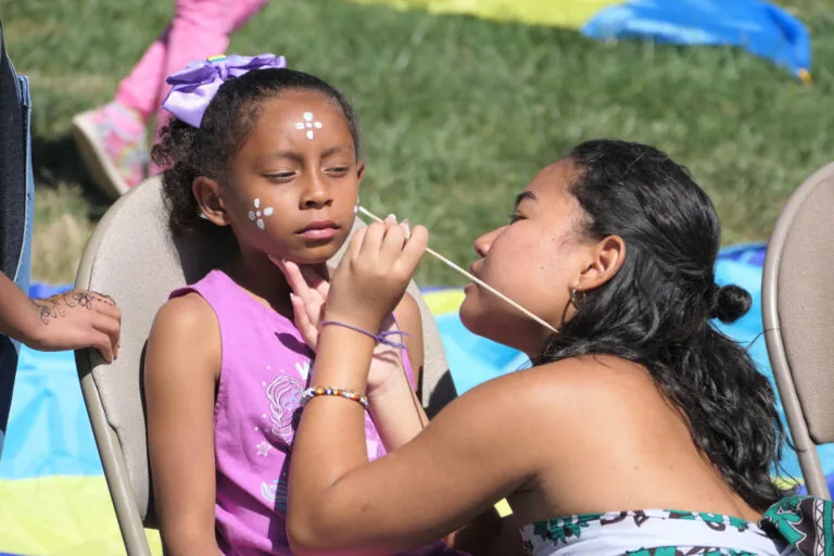 UWC-USA student paints face of a child from the local Las Vegas, New Mexico community for UWC Day.