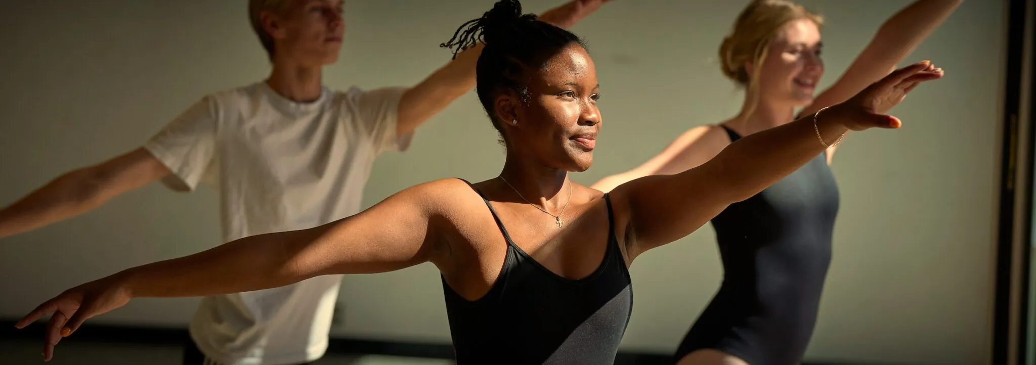 Students from diverse background dance in the sunlit dance studio in the Edith Lansing Field House at UWC-USA.