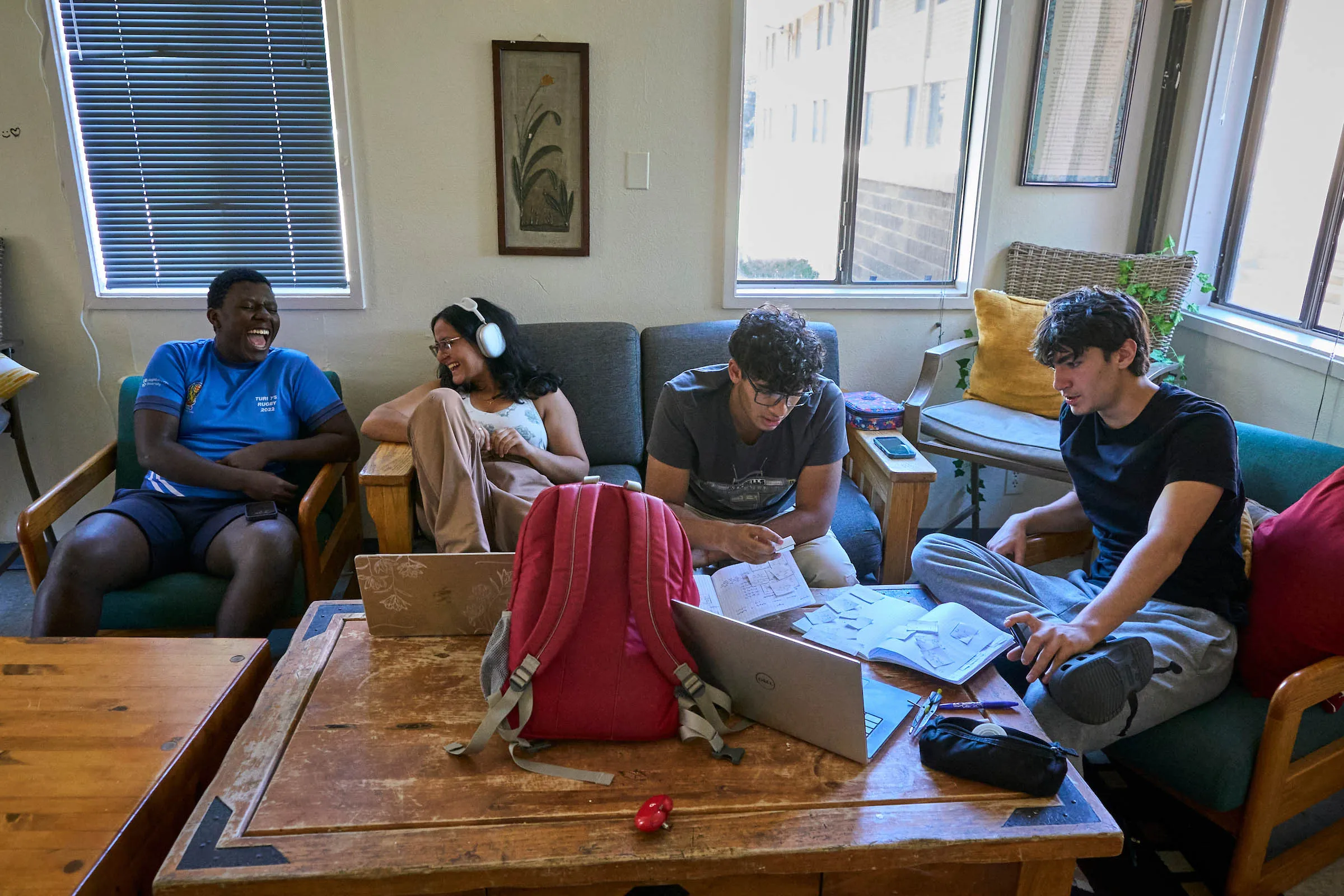 Diverse students collaborate in their dorm's day room, reflecting UWC-USA’s global community and commitment to service.
