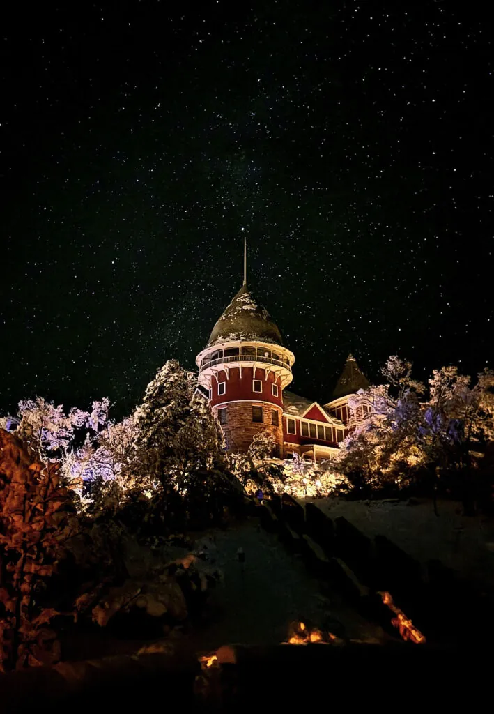 The Montezuma Castle on the UWC-USA campus in Montezuma, New Mexico under snowy trees and starlit sky, inspiring global learning.