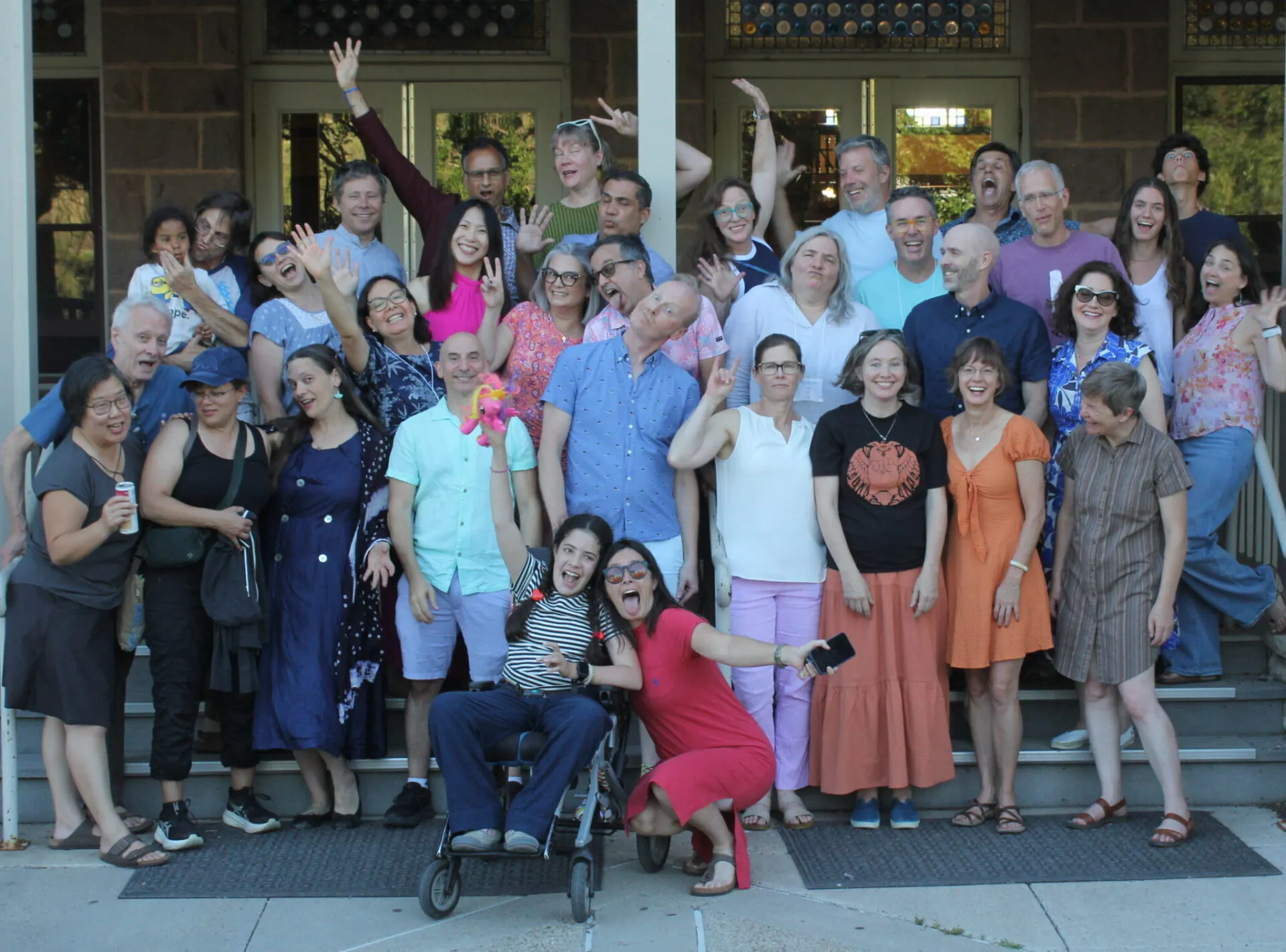 Diverse UWC-USA alumni gather on campus steps, reflecting UWC-USA’s global spirit and collaborative IB learning environment.