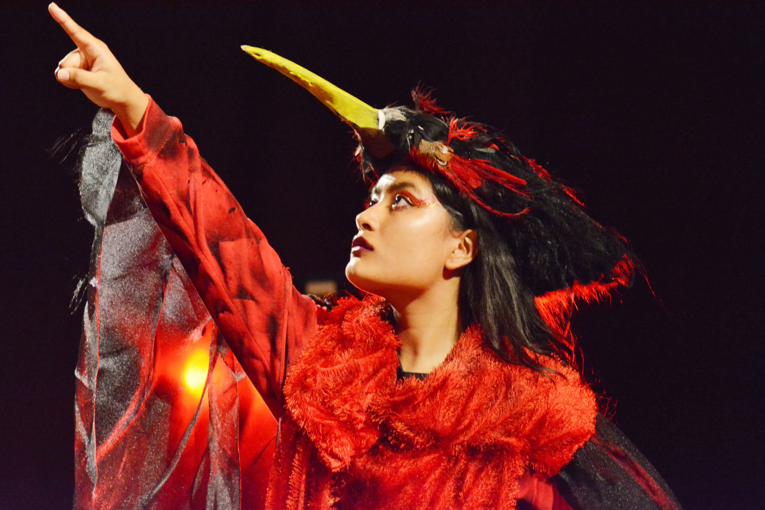 Student in elaborate cultural dress performing on stage as part of the arts & culture program at UWC-USA.